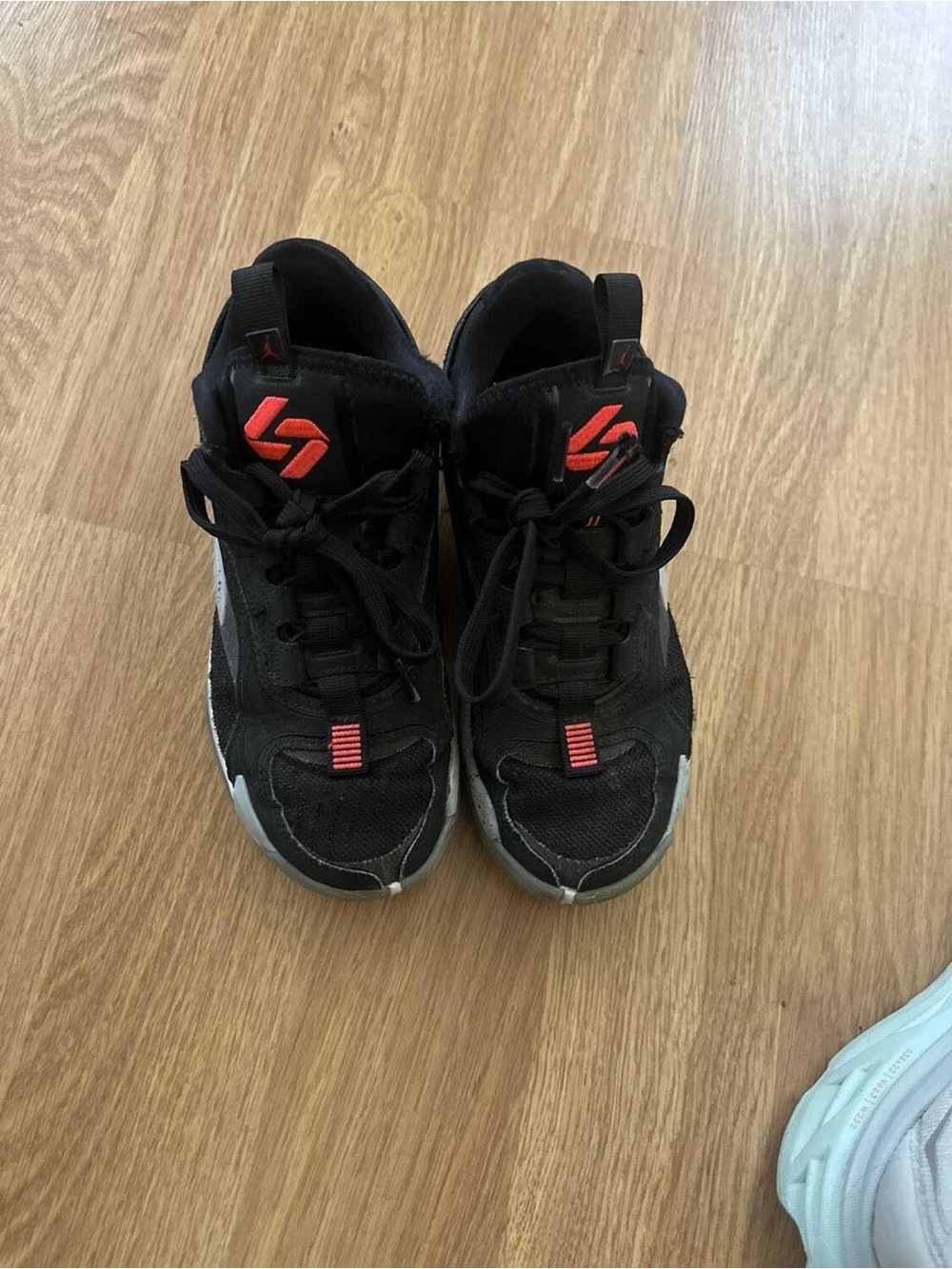 Jordan Kids Black Sneakers with Red-Orange Accents